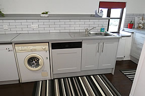 The kitchen includes a dishwasher and washer dryer