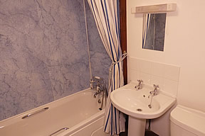 Bathroom with bath with shower over